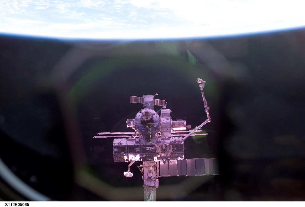 STS112-E-05065 (9 October 2002) --- The International Space Station (ISS) was photographed by a crewmember aboard the Space Shuttle Atlantis during rendezvous and docking operations. Docking occurred at 10:17 a.m. (CDT) on October 9, 2002.