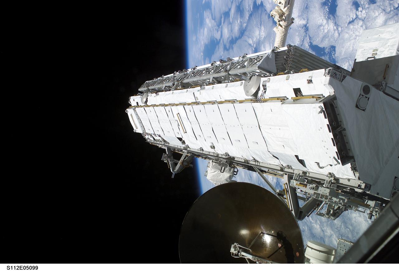 STS112-E-05099 (10 October 2002) --- Backdropped by the blackness of space and Earth&#0146;s horizon, the Starboard One (S1) Truss is moved from the Space Shuttle Atlantis&#0146; cargo bay. Astronauts Sandra H. Magnus, STS-112 mission specialist, and Peggy A. Whitson, Expedition Five flight engineer, used the Canadarm2 from inside Destiny laboratory on the International Space Station (ISS) to lift the S1 Truss out of the orbiter&#0146;s payload bay and move it into position at the starboard end of the S0 (S-Zero) Truss.