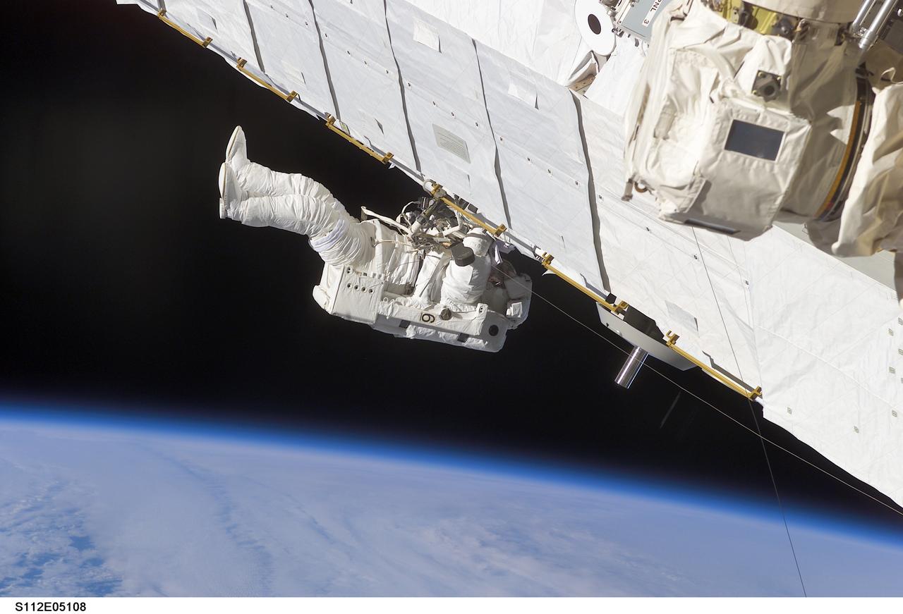 STS112-E-05108 (10 October 2002) --- Astronaut Piers J. Sellers, STS-112 mission specialist, works on the Starboard One (S1) Truss, newly installed on the International Space Station (ISS). Astronaut David A. Wolf (out of frame), mission specialist, worked in tandem with Sellers during the spacewalk. STS-112&#0146;s first session of extravehicular activity (EVA) lasted 7 hours and 1 minute.