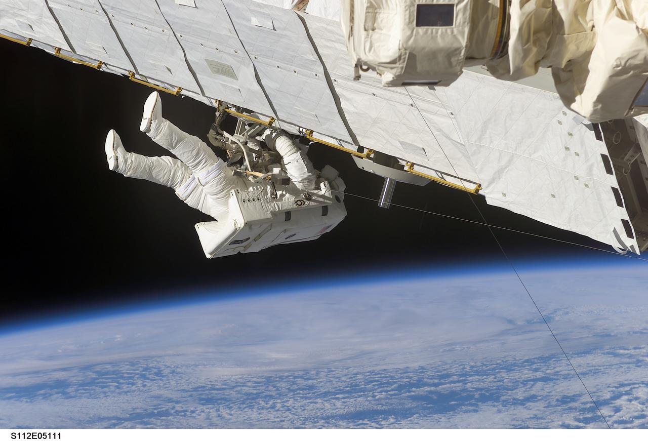 STS112-E-05111 (10 October 2002) --- Astronaut Piers J. Sellers, STS-112 mission specialist, works on the Starboard One (S1) Truss, newly installed on the International Space Station (ISS). Astronaut David A. Wolf (out of frame), mission specialist, worked in tandem with Sellers during the spacewalk. STS-112&#0146;s first session of extravehicular activity (EVA) lasted 7 hours and 1 minute.