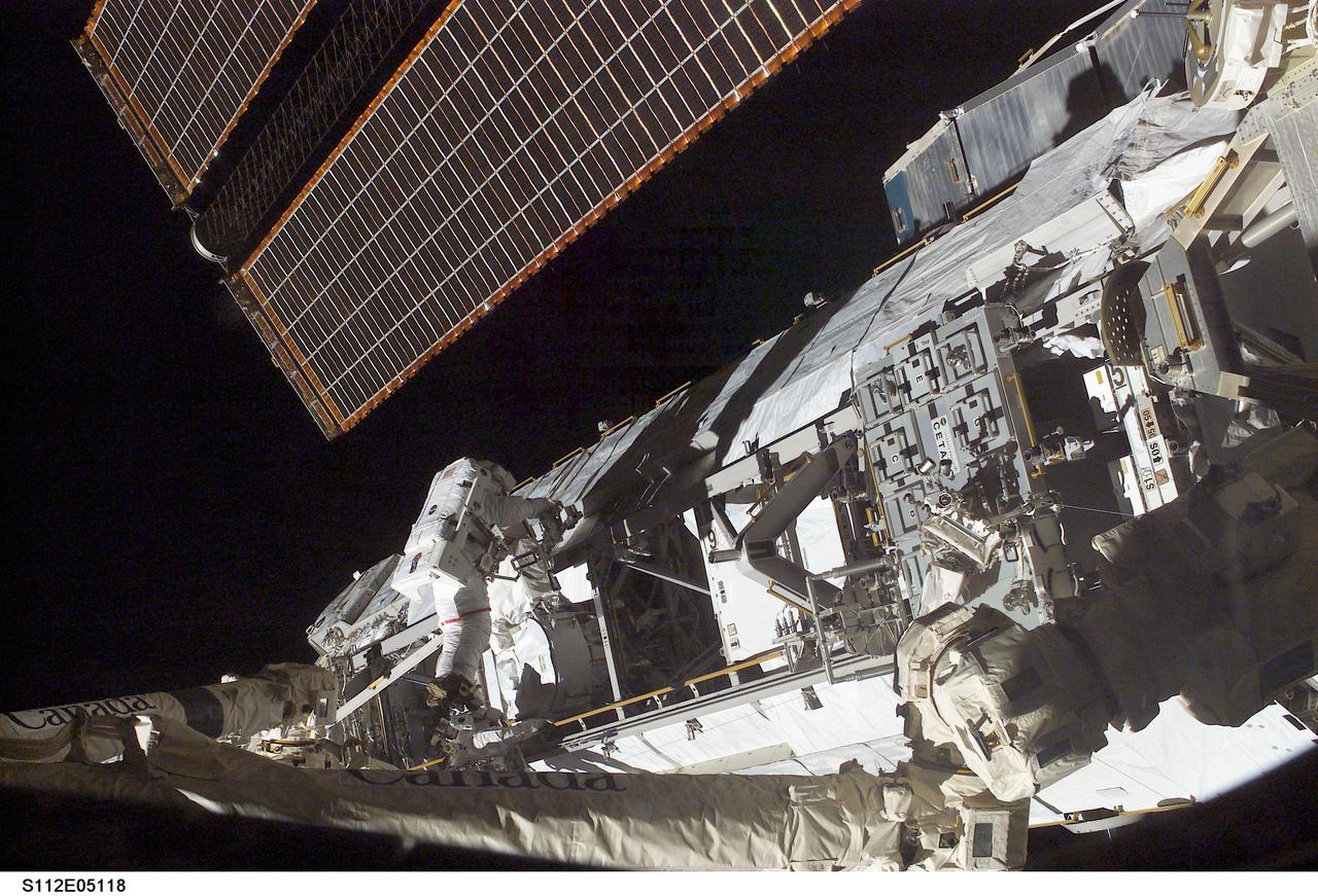 STS112-E-05118 (10 October 2002) --- Astronaut David A. Wolf, STS-112 mission specialist, works on the Starboard One (S1) Truss, newly installed on the International Space Station (ISS). Astronaut Piers J. Sellers (out of frame), mission specialist, worked in tandem with Wolf during the spacewalk. STS-112&#0146;s first session of extravehicular activity (EVA) lasted 7 hours and 1 minute.