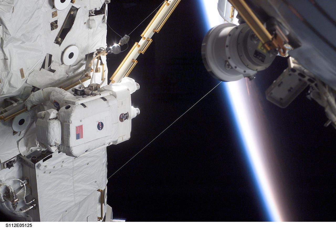 STS112-E-05125 (10 October 2002) --- Astronaut Piers J. Sellers, STS-112 mission specialist, works on the Starboard One (S1) Truss, newly installed on the International Space Station (ISS). Astronaut David A. Wolf (out of frame), mission specialist, worked in tandem with Sellers during the spacewalk. STS-112&#0146;s first session of extravehicular activity (EVA) lasted 7 hours and 1 minute.
