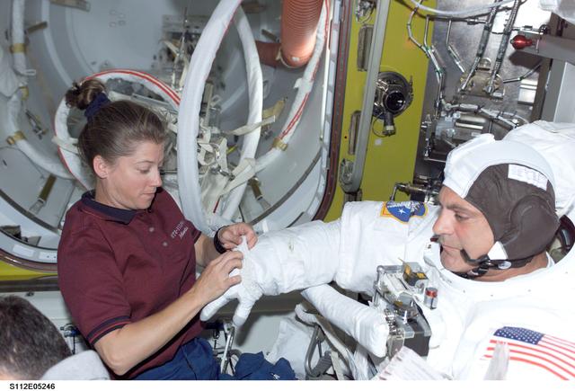 NASA image: MS Wolf prepares for EVA 2 with help from PLT Melroy
