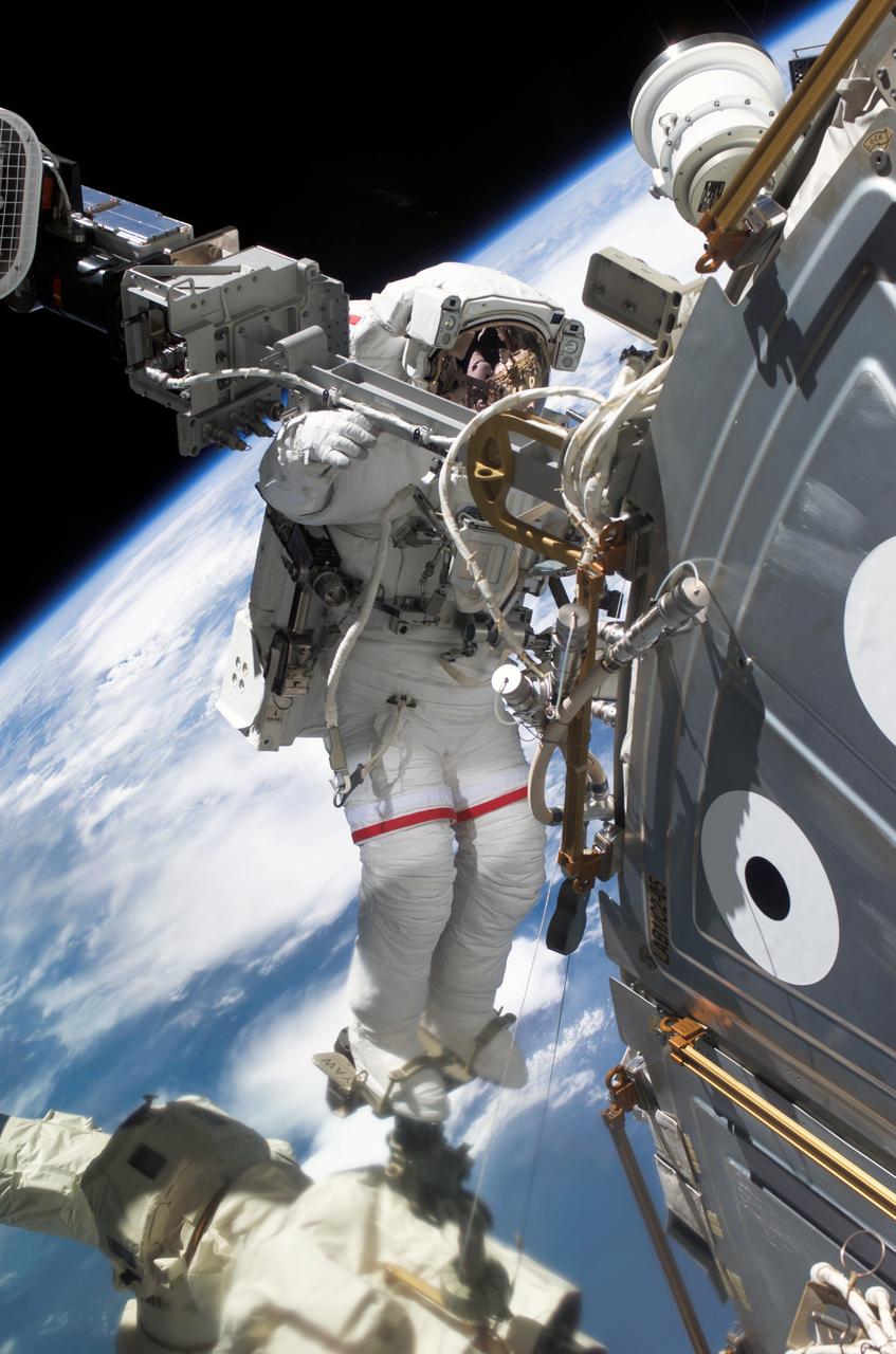 S112-E-05315 (12 Oct. 2002) --- Astronaut David A. Wolf, STS-112 mission specialist, carries out a task to install an additional exterior station television camera outside of the Destiny Laboratory during the second spacewalk of the STS-112 mission.  Astronauts Wolf and Piers J. Sellers are scheduled for a total of three spacewalks for the mission.