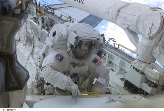 NASA image: MS Sellers retrieves tool during EVA 2
