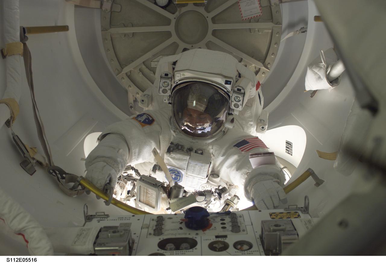 STS112-E-05516 (14 October 2002) --- Astronaut David A. Wolf, STS-112 mission specialist, exits the Quest Airlock on the International Space Station (ISS) to begin the third and final scheduled session of extravehicular activity (EVA) for the STS-112 mission. Astronaut Piers J. Sellers (out of frame), mission specialist, joined Wolf on the spacewalk.