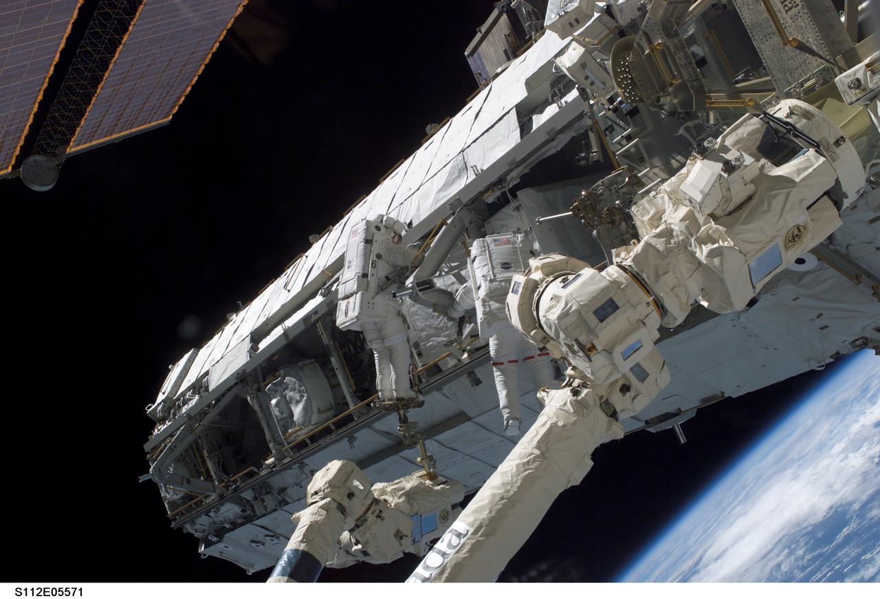 STS112-E-05571 (14 October 2002) --- Astronauts Piers J. Sellers (left) and David A. Wolf, STS-112 mission specialists, work on the newly installed Starboard One (S1) Truss during the third and final scheduled session of extravehicular activity (EVA) for the STS-112 mission. The spacewalk lasted 6 hours and 36 minutes.