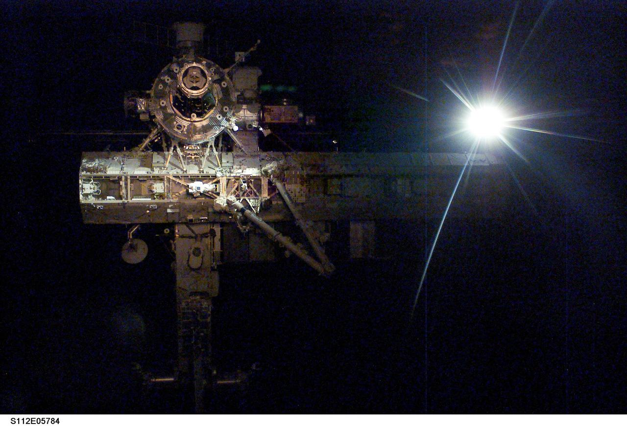 STS112-E-05784 (16 October 2002) --- Backdropped by the blackness of space and a sunburst, this close-up view of the International Space Station (ISS) was photographed by a crewmember on board the Space Shuttle Atlantis following the undocking of the two spacecraft. Atlantis pulled away from the complex at 8:13 a.m. (CDT) on October 16, 2002. The newly added Starboard One (S1) Truss is visible in center right frame.