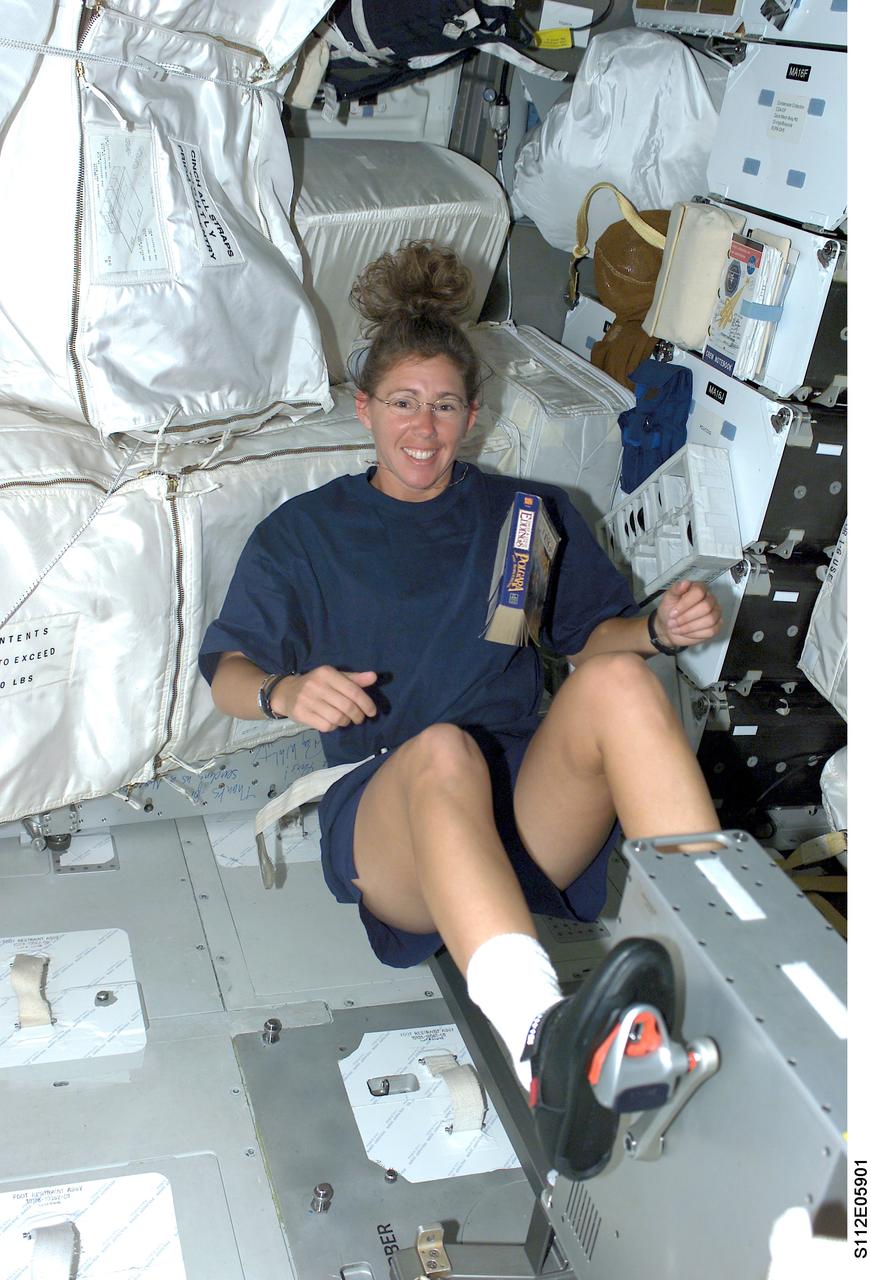 STS112-E-05901 (16 October 2002) --- Astronaut Sandra H. Magnus, STS-112 mission specialist, works out on a bicycle ergometer on the middeck of the Space Shuttle Atlantis.