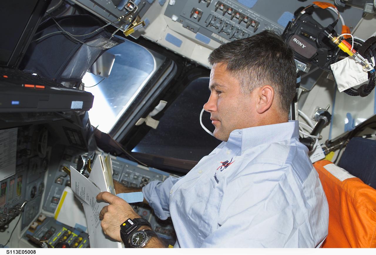 STS113-E-5008 (25 November 2002) --- Astronaut Paul S. Lockhart, pilot,  works at the pilot's station on the flight deck of the Space Shuttle Endeavour during the second day of STS-113 activity. The STS-113 astronauts went on to dock the shuttle with the International Space Station at 3:59 p.m. (CST), bringing a new crew and another segment of the station's backbone, the Port One (P1) segment of the Integrated Truss System. The rendezvous and docking of Endeavour with astronaut James D. Wetherbee (out of frame), mission  commander, at the controls, occurred about 248 statute miles above the South Pacific off the southeastern coast of Australia.