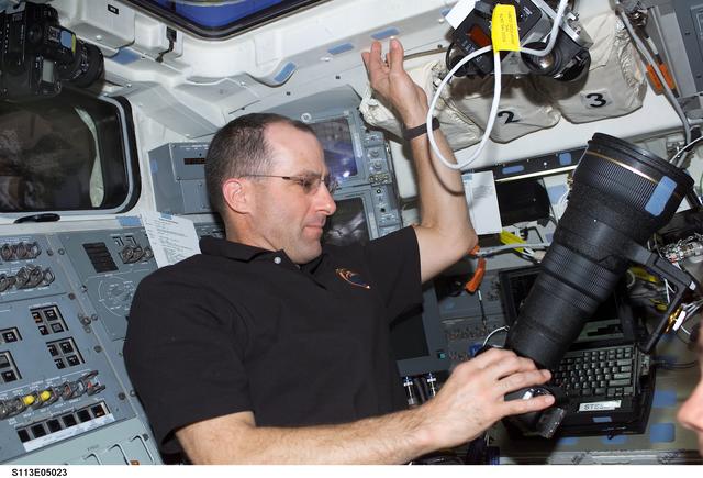 NASA image: Expedition Six Flight Engineer Don Pettit adjusts camera on AFD during STS-113
