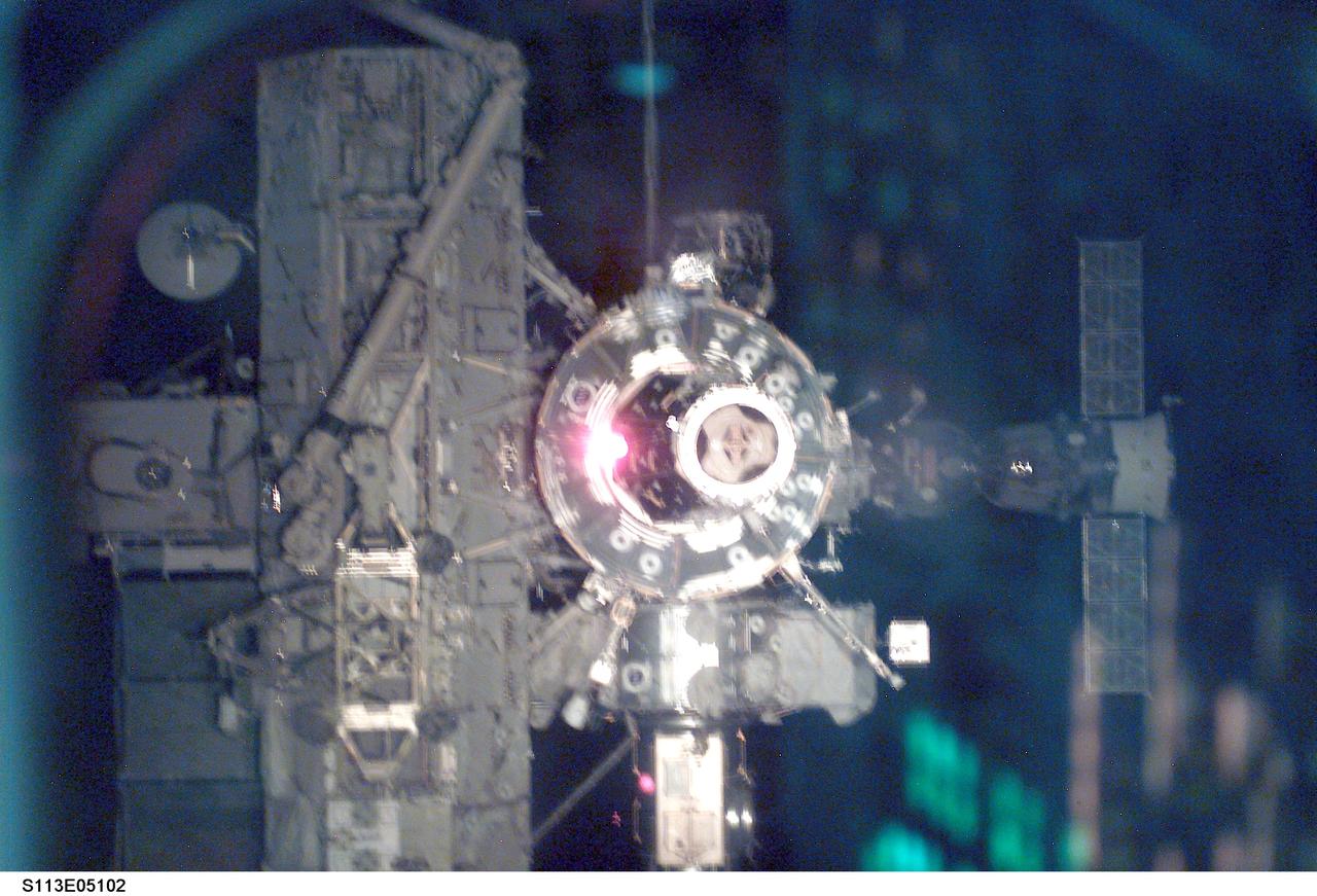 ISS views - PMA2, U.S. Lab, SSRMS, AL, S0 Truss, and Soyuz during Docking Operations for STS-113