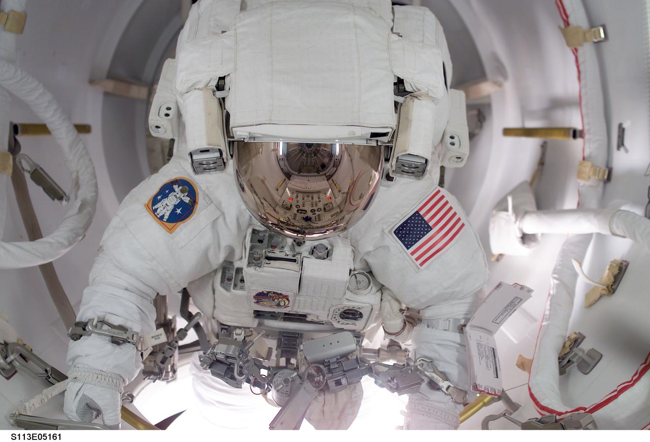 STS113-E-05161 (26 November 2002) --- Astronaut John B. Herrington prepares to egress the airlock to begin the first of three scheduled STS-113 spacewalks to perform work on the International Space Station (ISS). In cooperation with the rest of the shuttle and station crewmembers, astronauts Herrington and Michael E. Lopez-Alegria, both mission specialists, went on to complete a smooth spacewalk to hook up connections  between the Port One (P1) truss and the rest of the station.