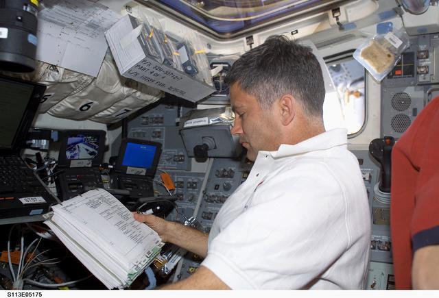 NASA image: PLT Paul Lockhart working on the AFD during EVA2 docked ISS OPS for STS-113