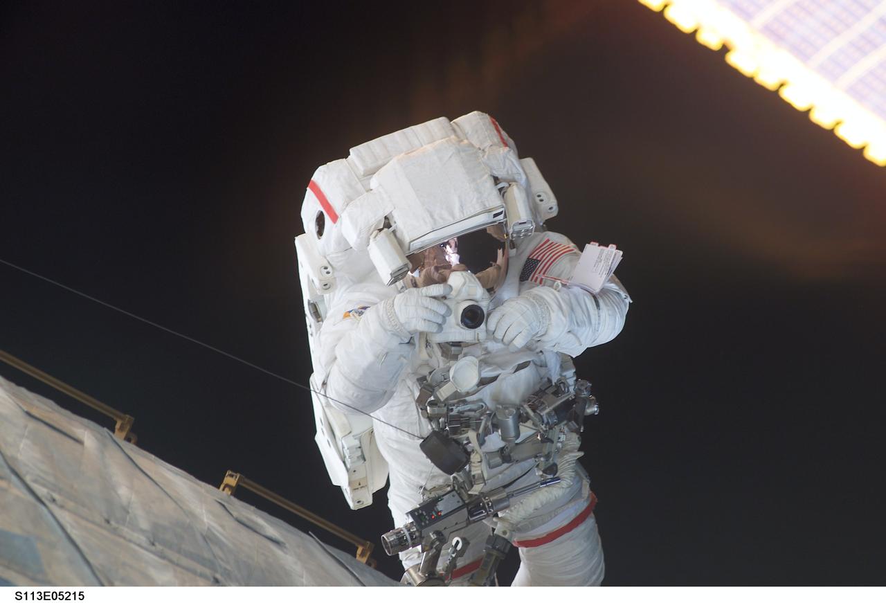 STS113-E-05215 (28 November 2002) --- Astronaut Michael E. Lopez-Alegria, STS-113 mission specialist, uses a camera during the mission’s second scheduled session of extravehicular activity (EVA). The spacewalk lasted 6 hours, 10 minutes.