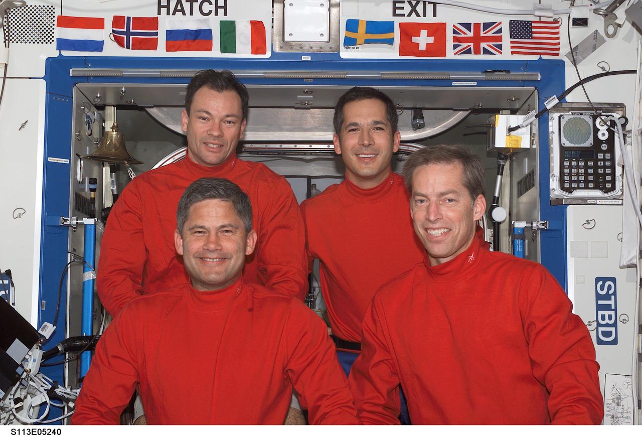 STS113-E-05240 (29 November 2002) --- The STS-113 crewmembers pose for a crew photo in the Destiny laboratory on the International Space Station (ISS). From the left, front row, are astronauts Paul S. Lockhart and James D. Wetherbee, pilot and mission commander, respectively. From the left, back row, are astronauts Michael E. Lopez-Alegria and John B. Herrington, mission specialists.