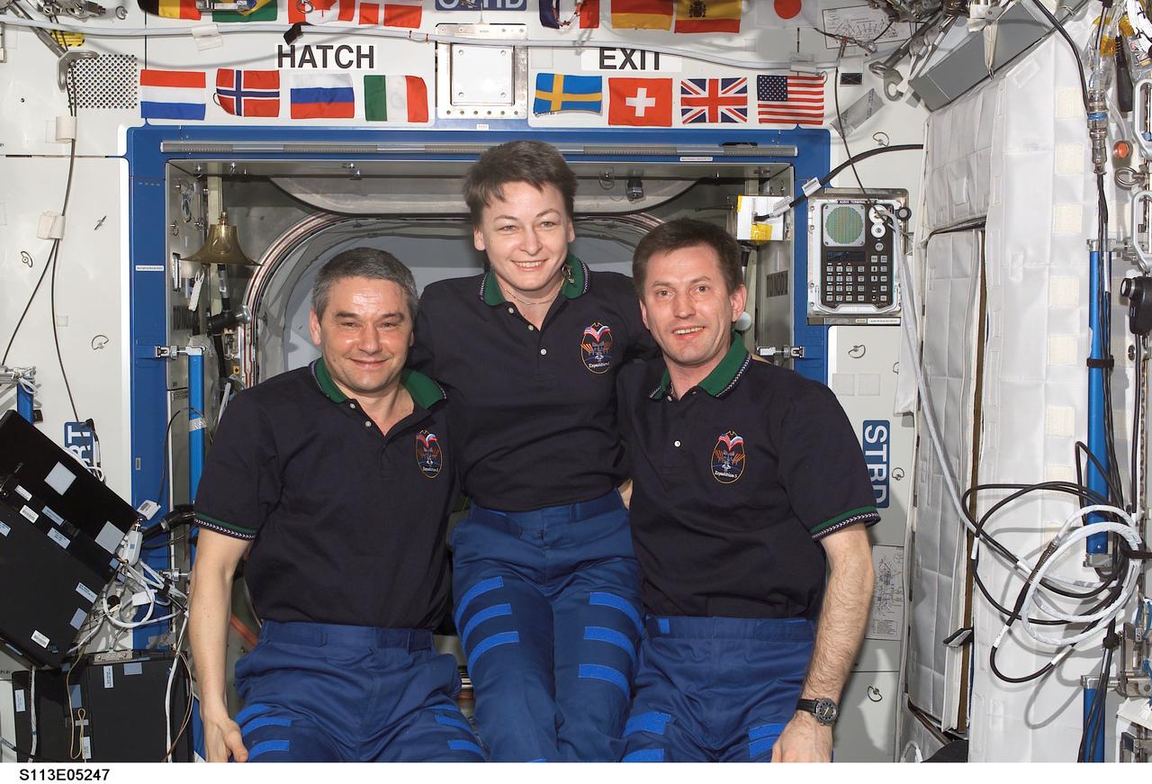 STS113-E-05247 (29 November 2002) --- The Expedition Five crewmembers pose for a crew photo in the Destiny laboratory on the International Space Station (ISS). From the left are cosmonaut Valery G. Korzun, mission commander; astronaut Peggy A. Whitson, NASA ISS science officer; and cosmonaut Sergei Y. Treschev, flight engineer. Korzun and Treschev represent Rosaviakosmos.
