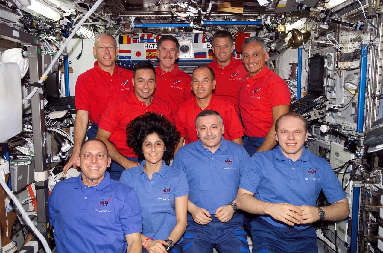 S117-E-07684 (16 June 2007) --- The STS-117 and Expedition 15 crewmembers gather for a group portrait during a joint crew press conference in the Destiny laboratory of the International Space Station while Space Shuttle Atlantis was docked with the station. From the left (front row) are astronauts Clayton Anderson, Expedition 15 flight engineer; Sunita Williams, STS-117 mission specialist; cosmonauts Fyodor N. Yurchikhin and Oleg V. Kotov, Expedition 15 commander and flight engineer, respectively, representing Russia's Federal Space Agency. From the left (middle row) are astronauts Lee Archambault and Rick Sturckow, STS-117 pilot and commander, respectively. From the left (back row) are astronauts Patrick Forrester, Jim Reilly, Steven Swanson and John "Danny" Olivas, all STS-117 mission specialists. Shortly after the two spacecraft docked on June 10, Anderson became a member of the station crew. At the same time, Williams became an Atlantis crewmember for her ride home, completing more than six months in space.