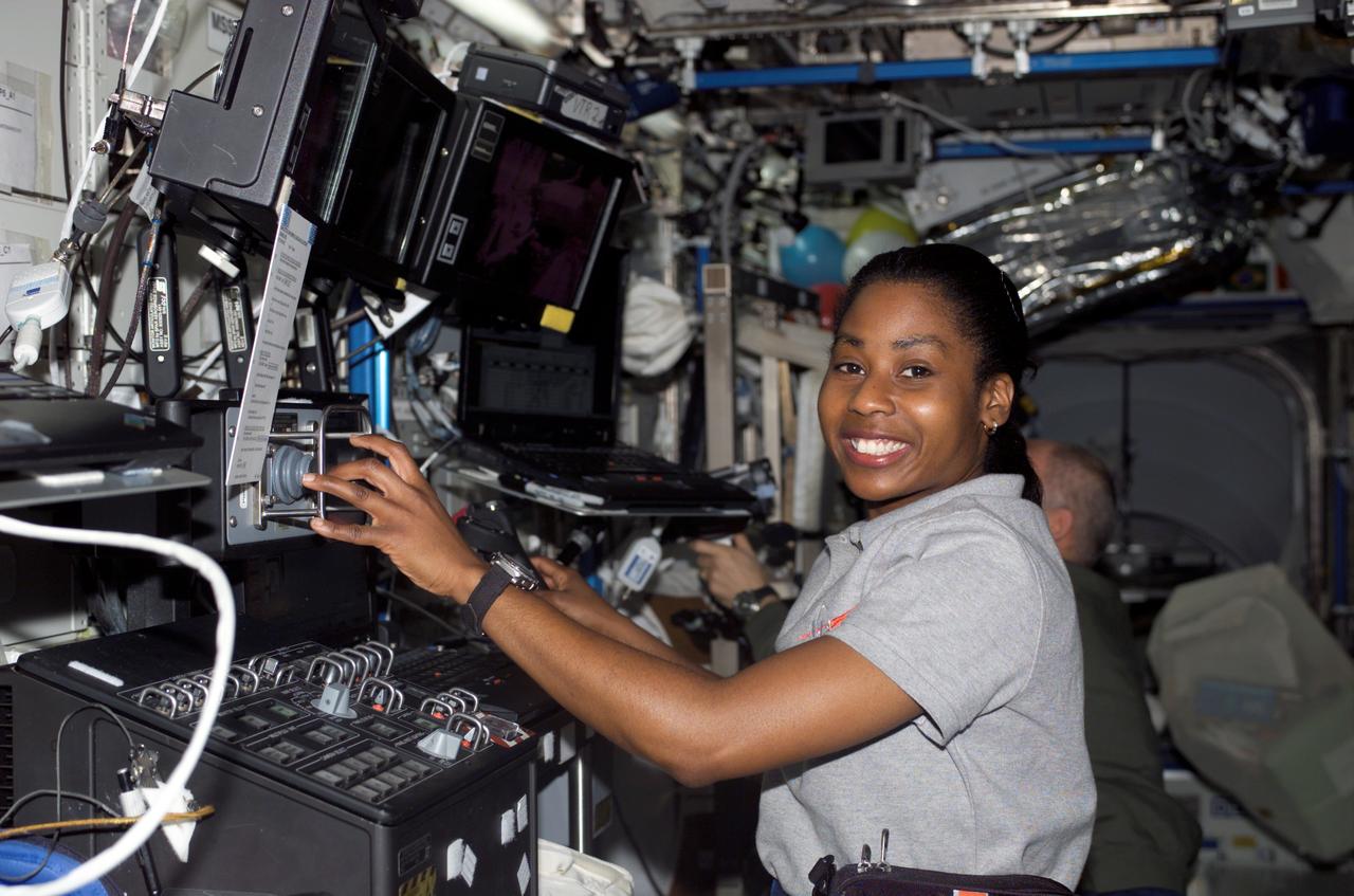 S121-E-07694 (15 July 2006) --- Astronaut Stephanie D. Wilson, STS-121 mission specialist, works with the Mobile Service System (MSS) and Canadarm2 controls in the Destiny laboratory of the International Space Station while Space Shuttle Discovery was docked to the station.