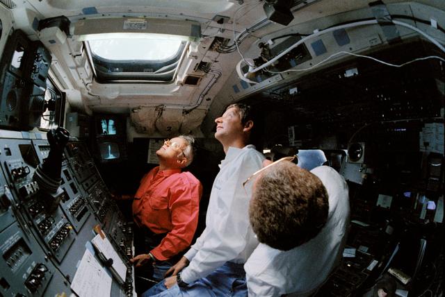 NASA image: STS-31 crew monitors Hubble Space Telescope (HST) from OV-103's flight deck
