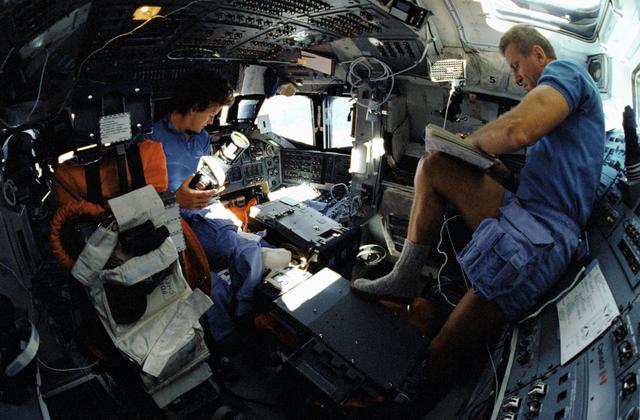 NASA image: STS-31 MS Sullivan and Commander Shriver work on the OV-103's flight deck