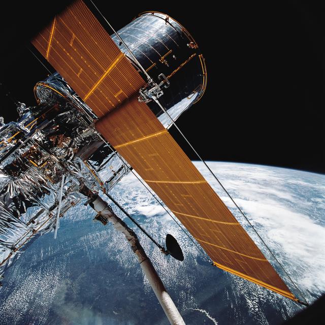 STS-31 Hubble Space Telescope (HST) (SA & HGA deployed) is grappled by RMS