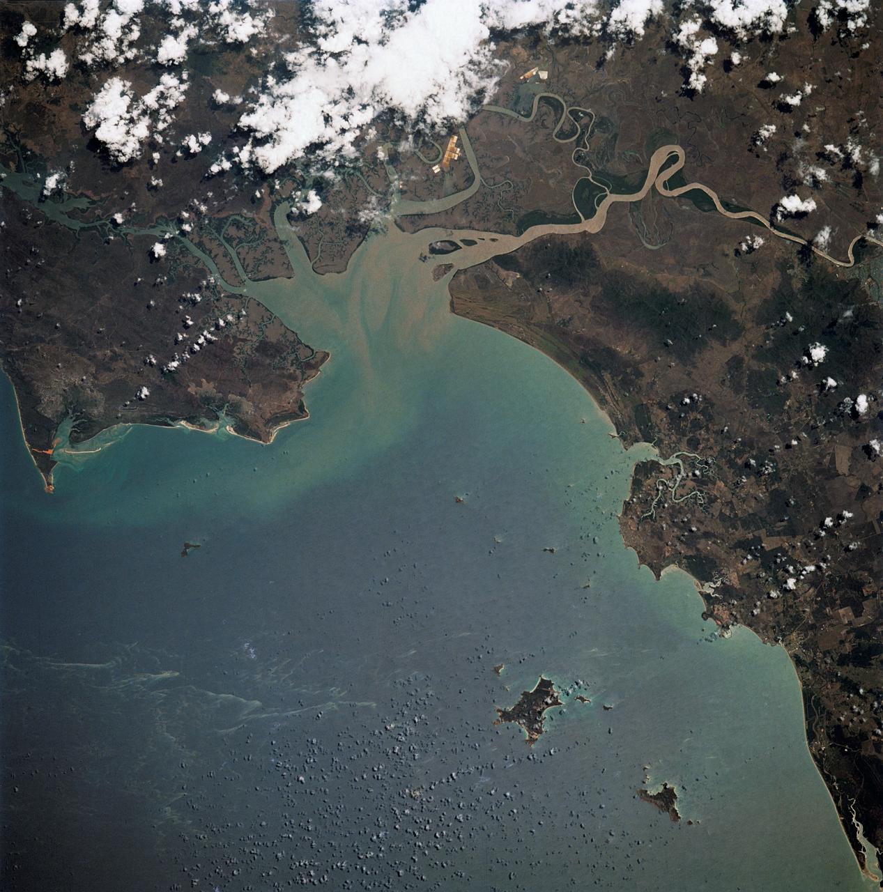 STS032-520-014 (9-20 Jan. 1990) --- STS-32 astronauts took this 70mm scene showing phytoplankton oralgal bloom in the northwest Coral Sea. The Western Coral Sea and the Great Barrier Reef waters offshore Queensland, Australia are the sites of some of the larger concentrations or "blooms" of phytoplankton and algae in the open ocean. In the instance illustrated here, the leading edge of a probable concentration of algae or phytoplankton is seen as a light irregular line and sheen between the offshore Great Barrier Reef and the Queensland coast. Previous phytoplankton concentrations in this area have been reported by ships at sea as having formed floating mats as thick as two meters. This picture was used by the STS-32 astronauts at their Jan. 30, 1990 post-flight press conference.