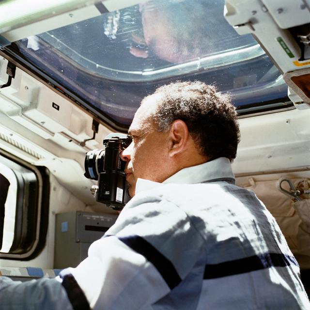 STS-33 Commander Gregory uses a NIKON 35mm camera on OV-103's aft flight deck