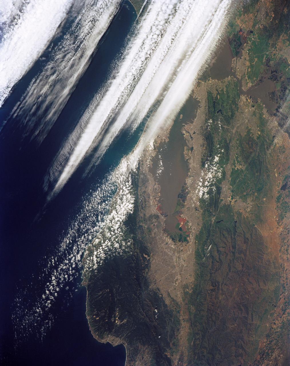 STS039-151-181A (28 April-6 May 1991) --- Large format (five-inch) frame of the San Francisco/Oakland Bay Area of northern California.  Stratus clouds at 35,000 feet and cumulus clouds at about 15,000 feet are seen over the Pacific Coast, obscuring the Golden Gate Bridge.