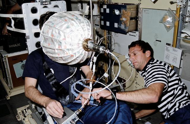 NASA image: STS-42 MS Hilmers and Payload Specialist Merbold use IML-1 visual stimulator