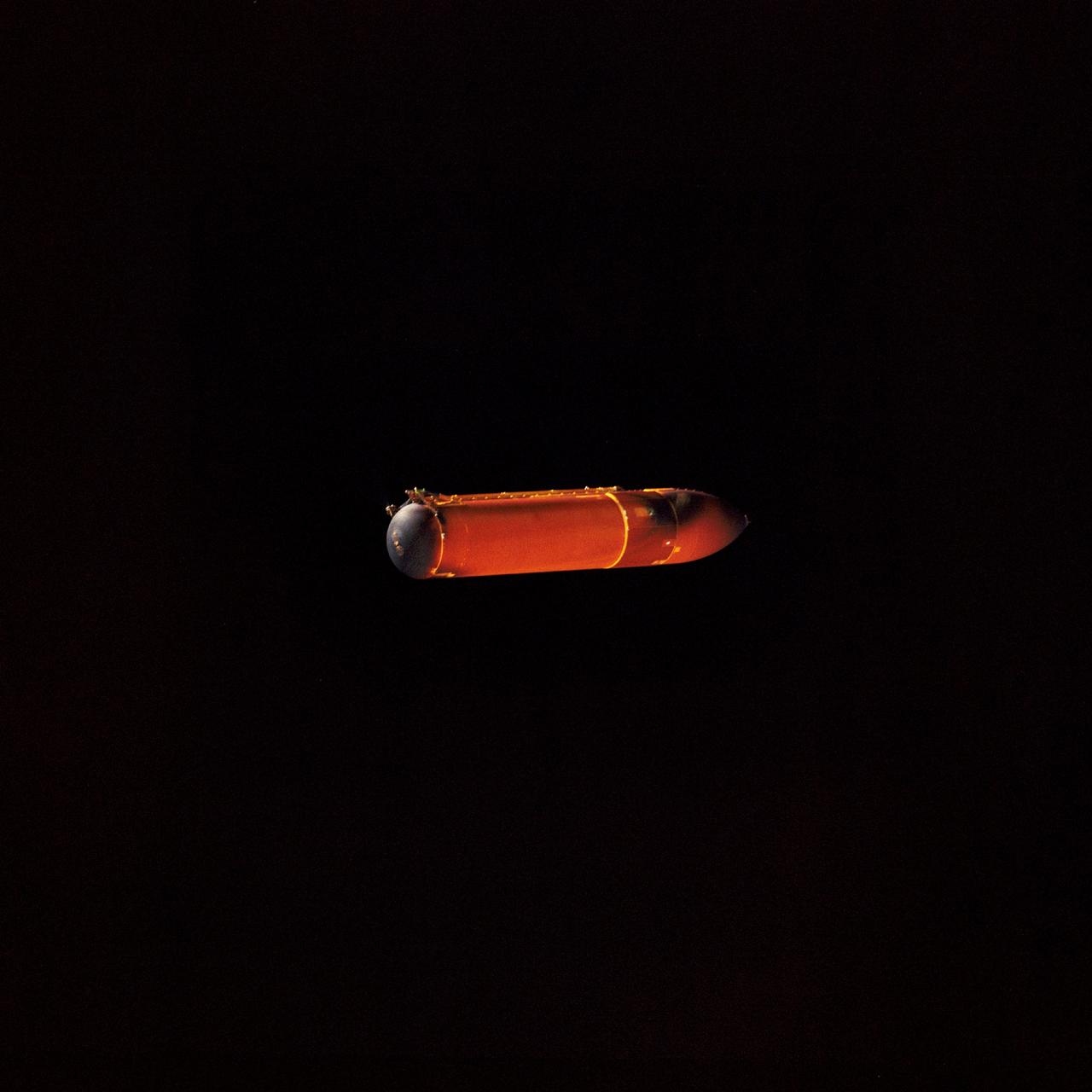 STS045-71-001 (24 March 1992) --- This 70mm photograph of the external fuel tank (ET) for STS-45 was photographed 4 1/2 minutes after having been jettisoned from Space Shuttle Atlantis. The excellent view of the starboard side of the ET shows both top and bottom attach points to the two solid rocket boosters (SRB). NASA engineers studying the STS-45 onboard photography deem the visible burn scars, caused by the SRBs, to be normal. The long thin pipe visible is the liquid oxygen line.  At the bottom end of the large tank, both the liquid oxygen (nearest camera) and liquid hydrogen orbiter-to-ET attach hardware can be seen.