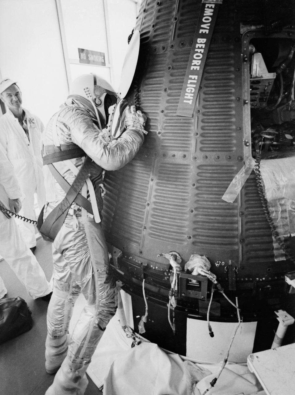 S61-02547 (5 May 1961) --- Astronaut Alan B. Shepard Jr., in his pressure suit and helmet, looks into the Freedom 7 capsule in preparation for ingress before the Mercury-Redstone 3 (MR-3) mission. Photo credit: NASA or National Aeronautics and Space Administration