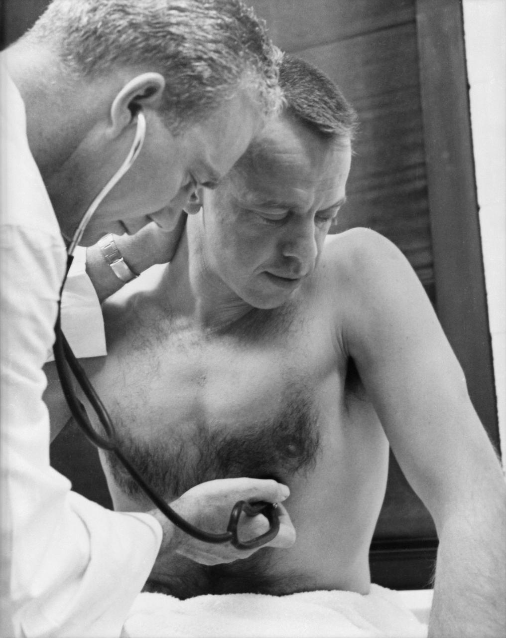 S61-02740 (5 May 1961) --- Astronaut Alan B. Shepard Jr. has his heart rate checked prior to his Mercury-Redstone 3 (MR-3) mission, the first American manned suborbital spaceflight. The attending physician is Dr. William K. Douglas. Photo credit: NASA or National Aeronautics and Space Administration