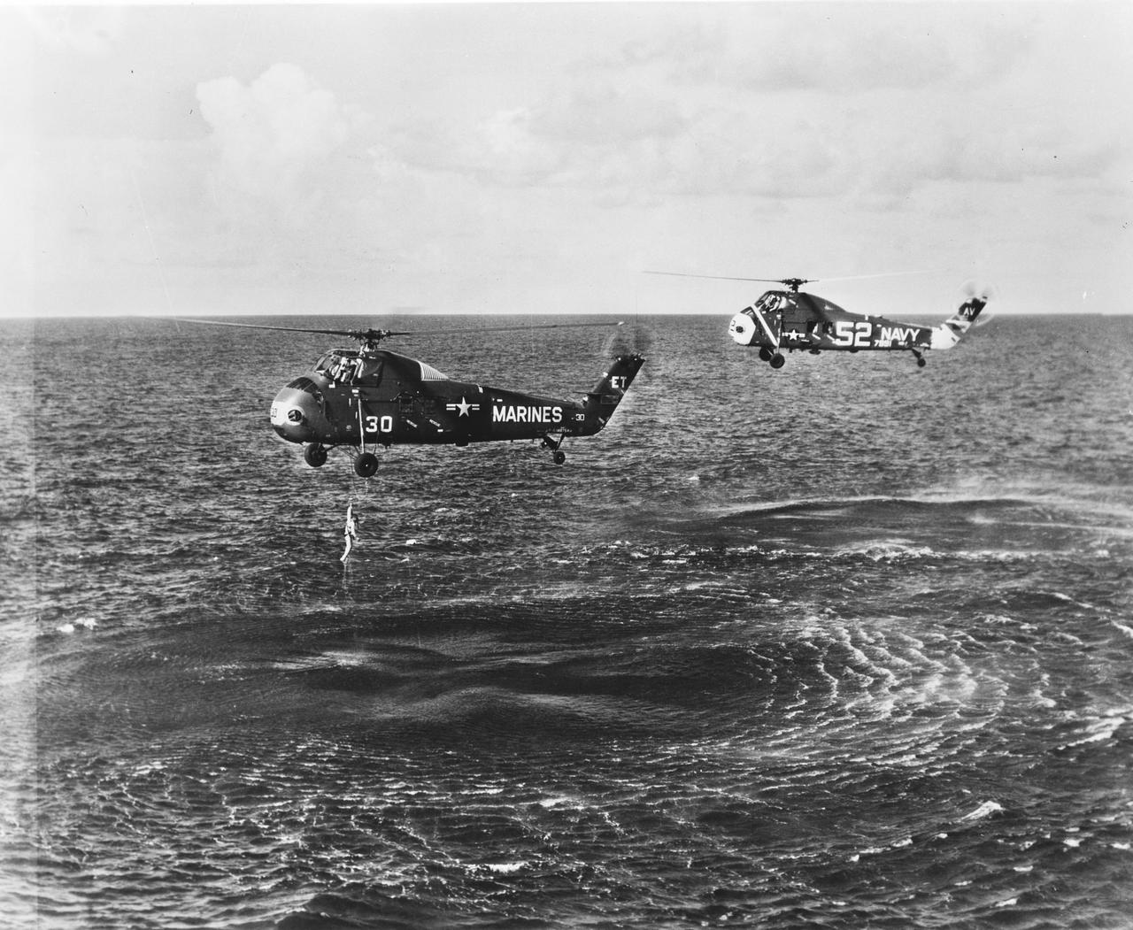 S61-02819 (21 July 1961) --- A U.S. Marine Corps helicopter retrieves astronaut Virgil I. Grissom from the Atlantic Ocean following the Mercury-Redstone 4 (MR-4) spaceflight.  Grissom's "Liberty Bell" Mercury spacecraft sank to the bottom of the ocean and was not recovered. Photo credit: NASA