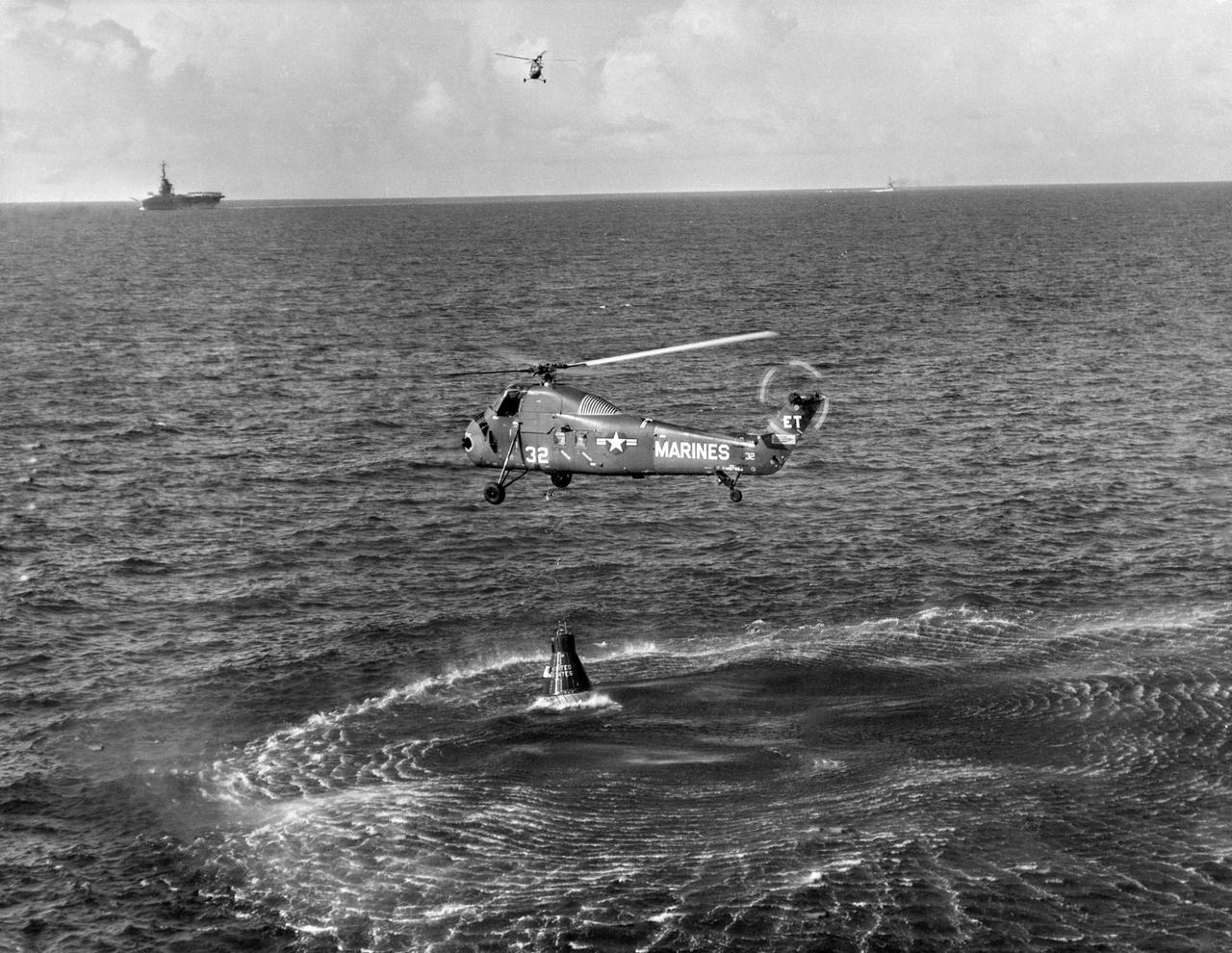 S61-02821 (21 July 1961) --- Attempted recovery of Mercury spacecraft at end of the Mercury-Redstone 4 (MR-4) mission. View shows the Marine helicopter dropping a recovery line to the capsule. In the upper left corner of the view, the recovery ship and another helicopter can be seen. Photo credit: NASA