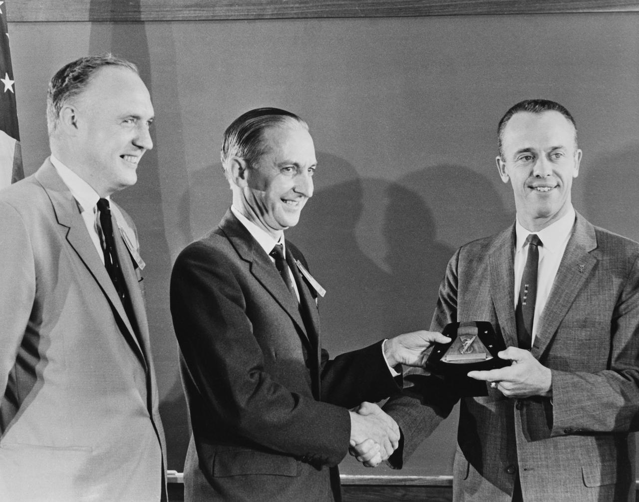 S61-03850 (1 Oct. 1961) --- Astronaut Alan B. Shepard Jr. (right) receives a plaque and award from members of the British Rocket Society. Photo credit: NASA or National Aeronautics and Space Administration