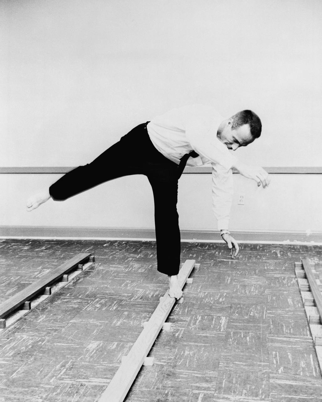 S61-04570 (1961) --- Astronaut M. Scott Carpenter's balance mechanism performance is tested by his walking on a narrow board in his bare feet. He is performing this test at the School of Aviation Medicine, Pensacola, Florida. Photo credit: NASA