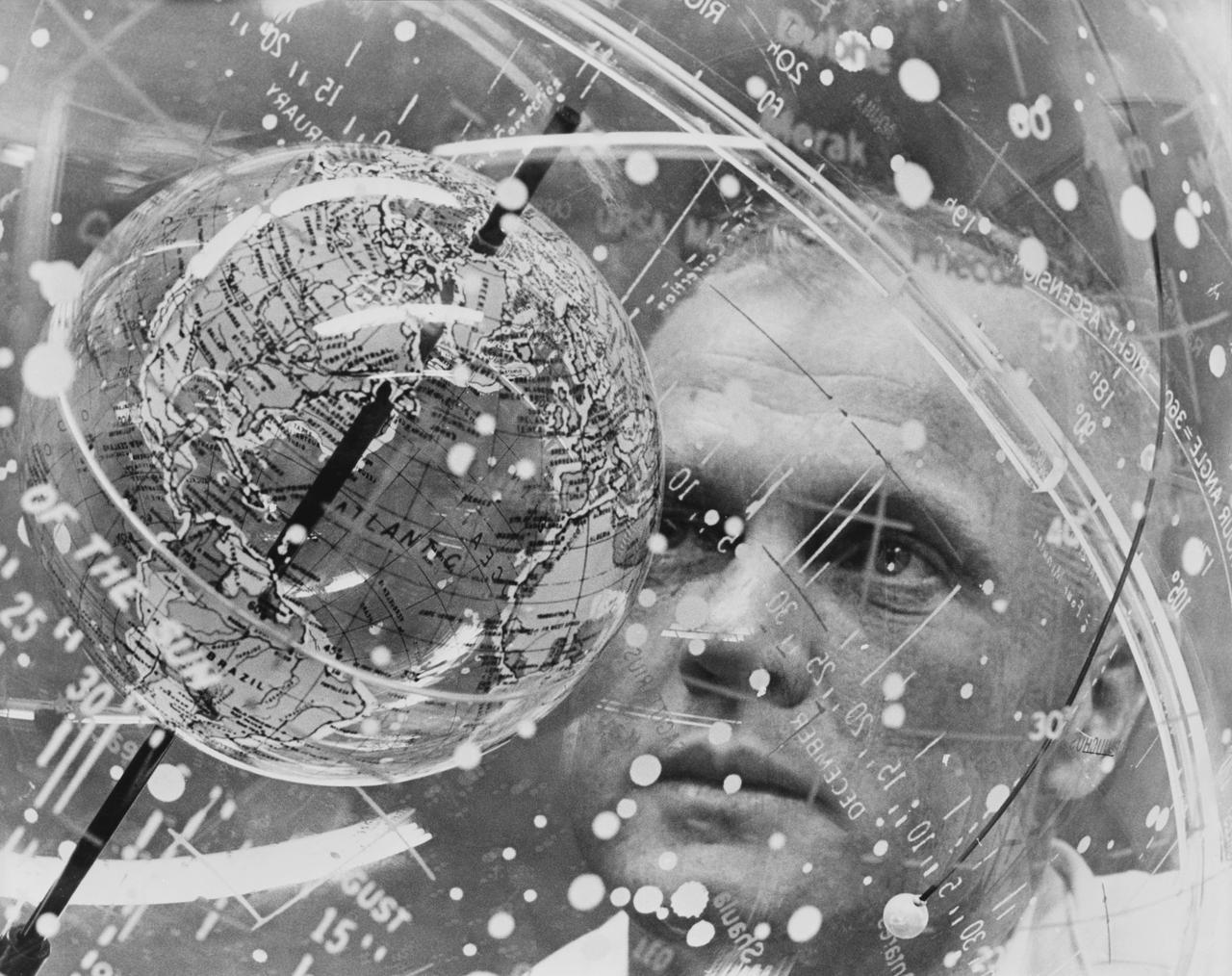 S61-04623 (1961) --- Astronaut John H. Glenn Jr. looks into a Celestial Training Device (globe) during training in the Aeromedical Laboratory at Cape Canaveral, Florida. Photo credit: NASA