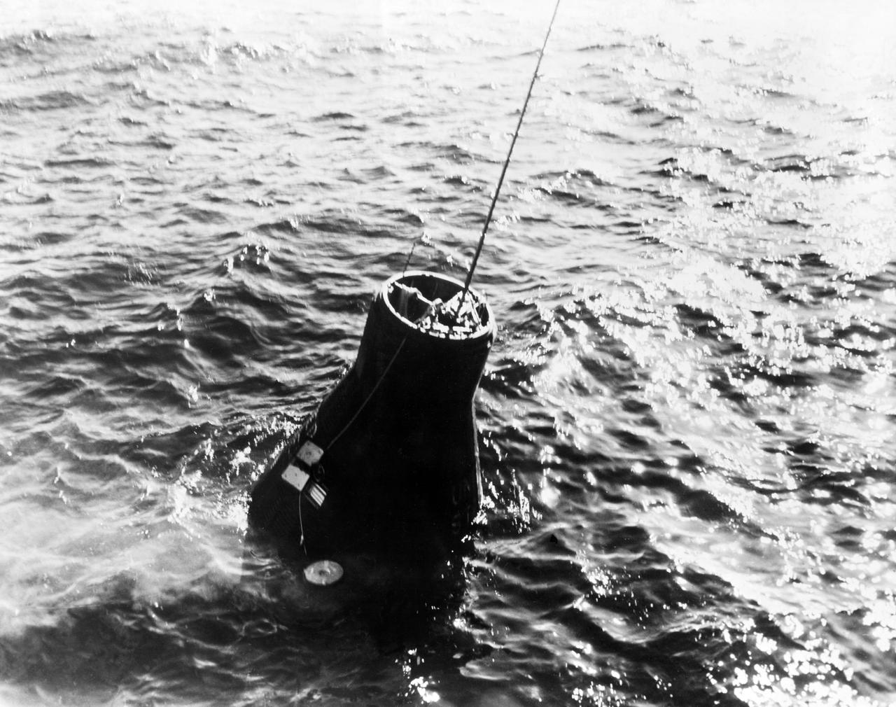 S62-00941 (20 Feb. 1962) --- The Mercury-Atlas 6 (MA-6) "Friendship 7" spacecraft is retrieved from the Atlantic Ocean following astronaut John H. Glenn Jr.'s three-orbit space mission. In this view, the capsule is still in the water, with retrieval cable connected to it. Photo credit: NASA