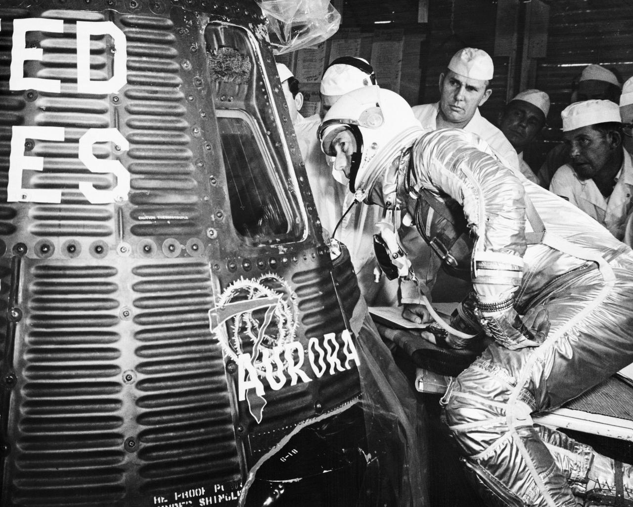 S62-03907 (24 May 1962) --- Astronaut M. Scott Carpenter looks into his Mercury-Atlas 7 spacecraft, the Aurora 7, before being inserted to begin the launch. Photo credit: NASA