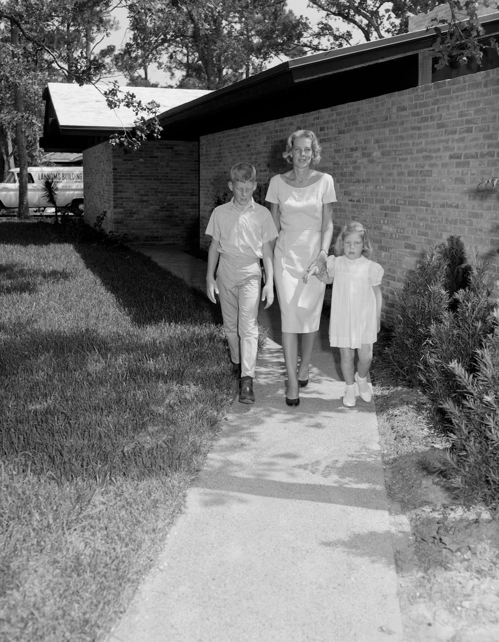 S62-04428 (1962)  --- Mrs. Wally schirra and her two children leave the Farnsworth-Chambers Building after a brief visit in 1962.  Photo credit: NASA