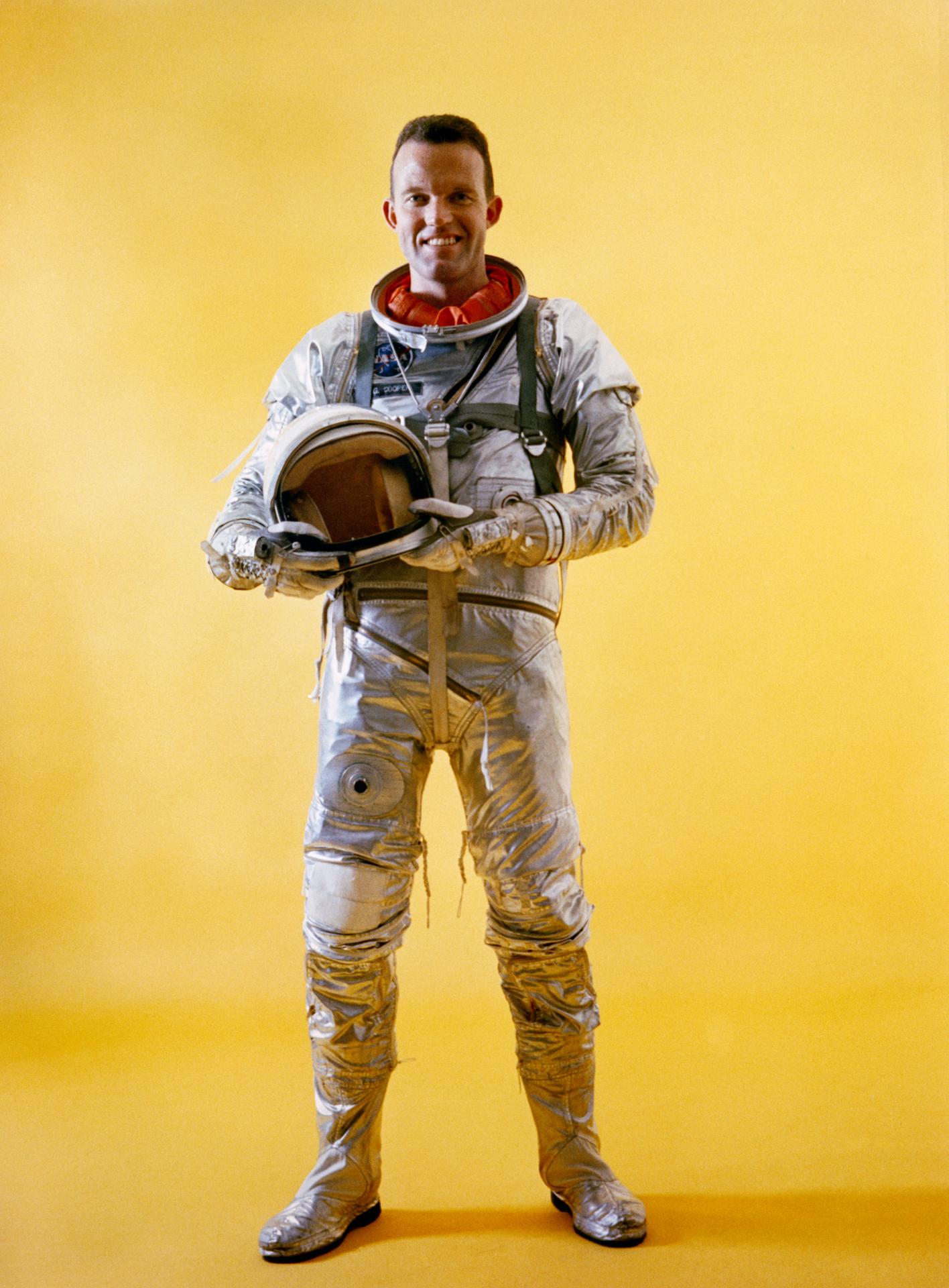 Full-length portrait of Mercury astronaut L. Gordon Cooper Jr., in spacesuit during Mercury-Atlas 9 prelaunch activities, holding his helmet in his hands.