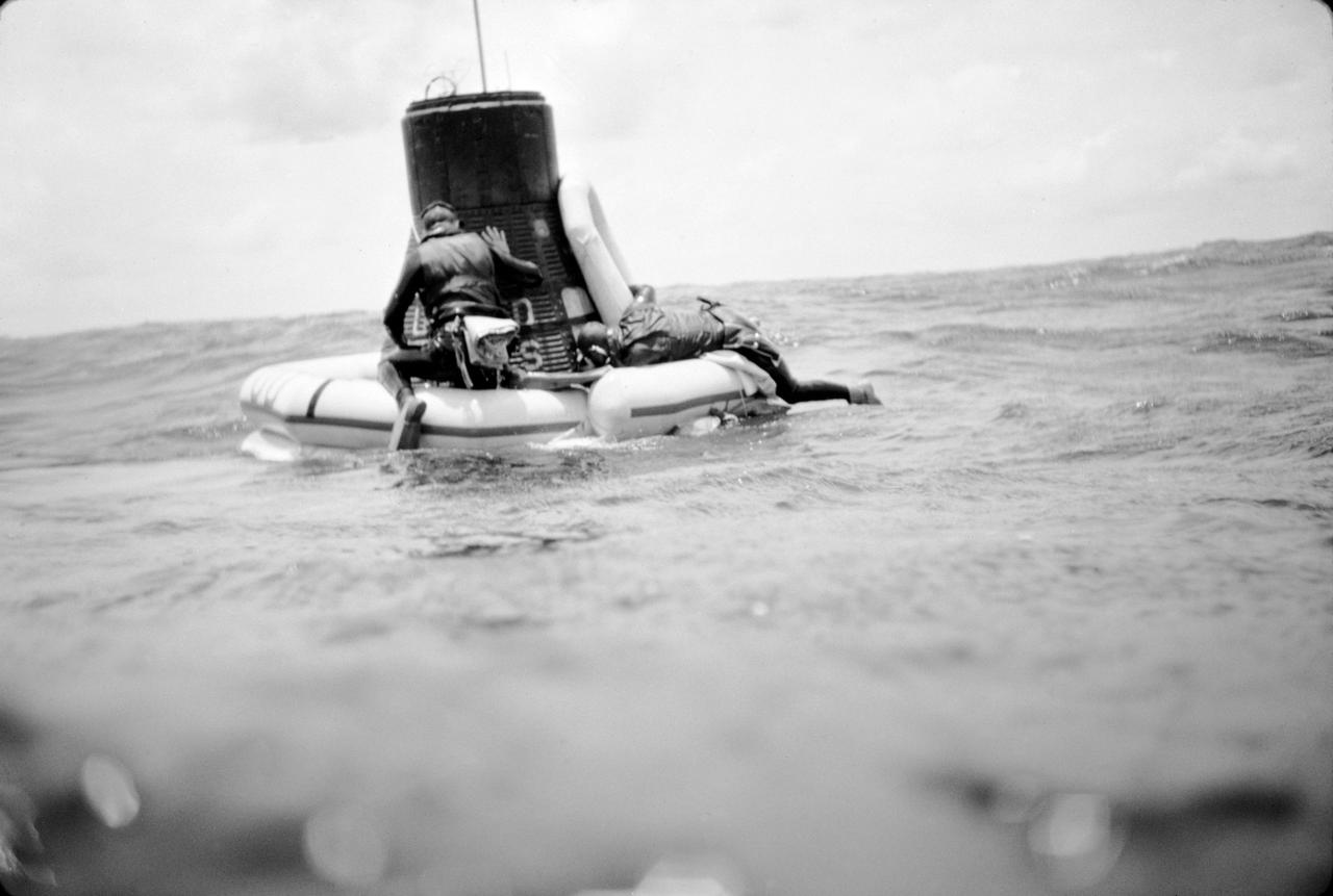 S63-07707 (16 May 1963) --- A U.S. Navy frogman team attaches a flotation collar to the Mercury-Atlas 9 (MA-9)"Faith 7" spacecraft during recovery operations in the central Pacific near Midway Island. The Mercury-Atlas spacecraft with astronaut L. Gordon Cooper Jr., pilot, still inside, was hoisted aboard the USS Kearnage. Photo credit: NASA