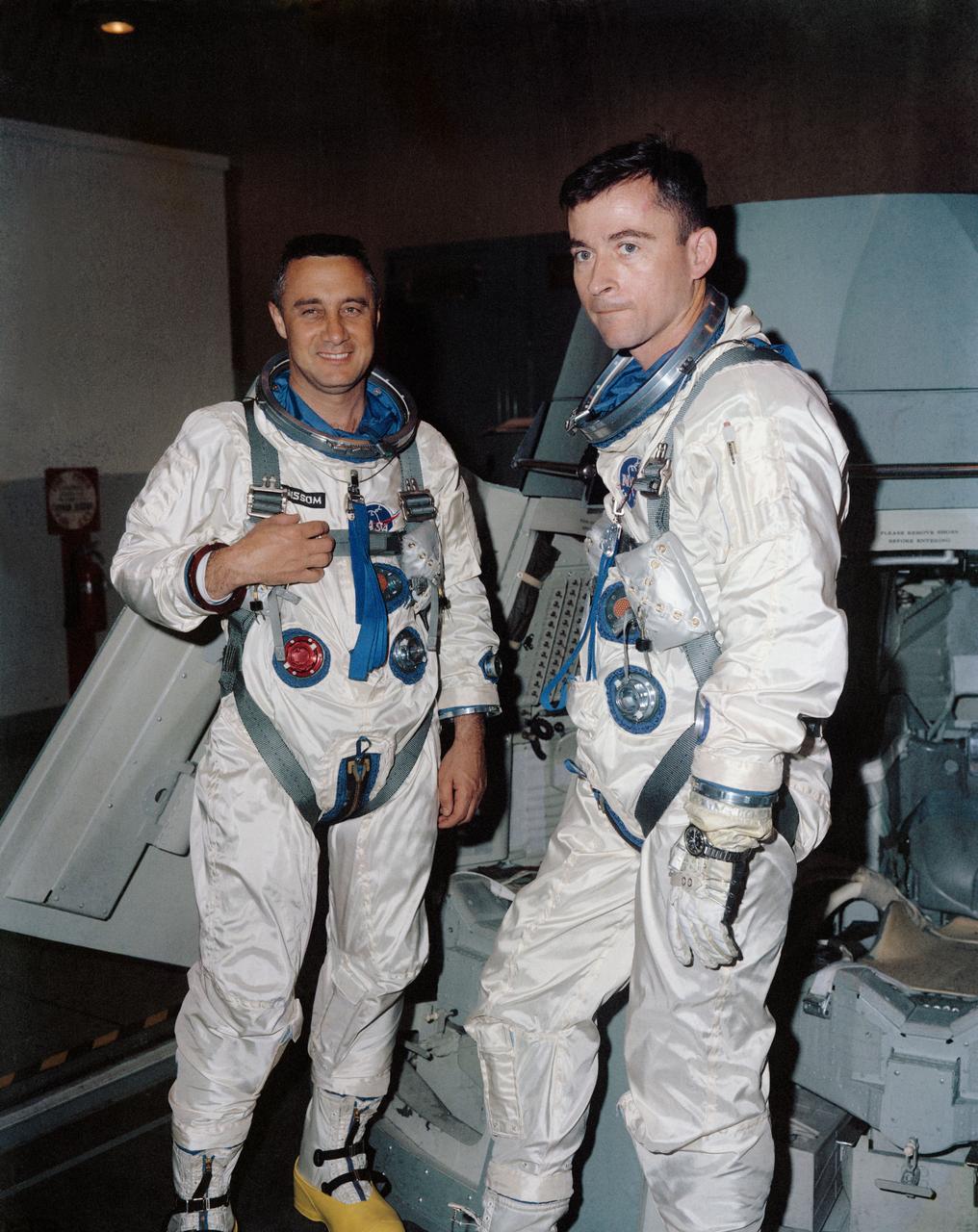 S65-14547 (26 Feb. 1965) --- The Gemini-Titan 3 prime crew, astronauts Virgil I. Grissom (left), command pilot, and John W. Young, pilot, are shown during flight simulation test activity at the Mission Control Center.