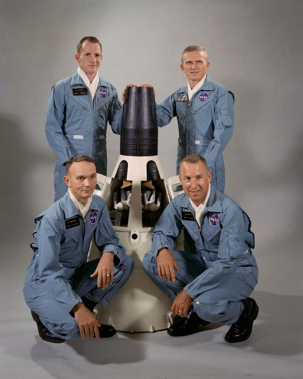 S65-41828 (September 1965) --- Portrait of the Gemini-7 prime and backup crew members around a model of the Gemini-7 spacecraft. The prime crew members for the Gemini-Titan 7 (GT-7) are astronauts Frank Borman (standing right), command pilot, and James A. Lovell Jr. (kneeling right), pilot. Astronauts Michael Collins (kneeling left), pilot, and Edward H. White II (standing left), command pilot, were named as GT-7 backup crew members on July 1, 1965. Photo credit: NASA