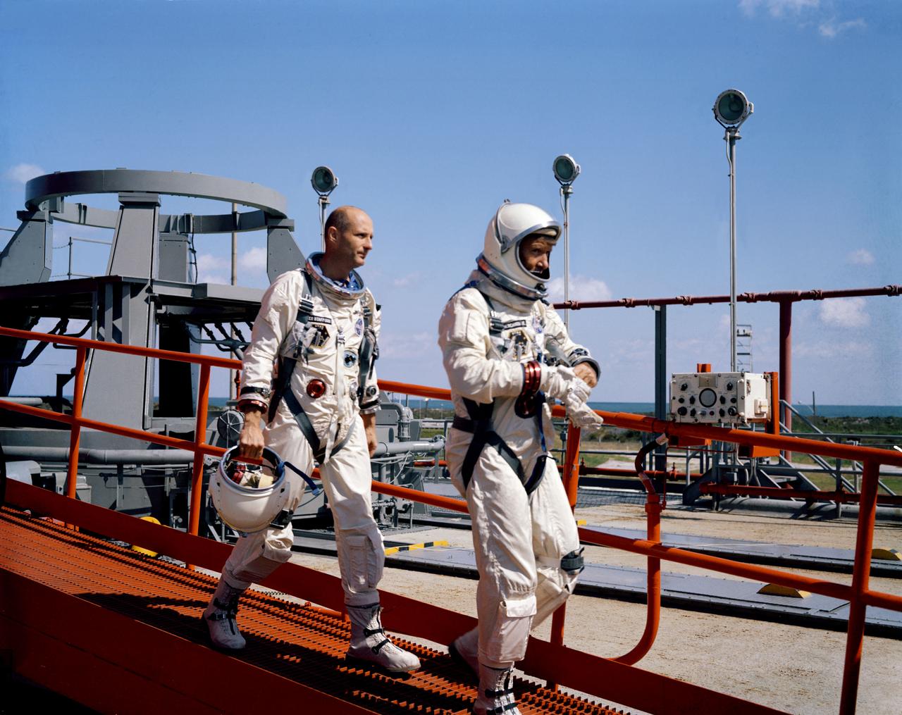 S65-57964 (25 Oct. 1965) --- The prime crew of the Gemini-6 spaceflight walk down the ramp at Pad 19 after leaving the Gemini-6 spacecraft. Astronaut Walter M. Schirra Jr. (leading) is command pilot; and astronaut Thomas P. Stafford is pilot. The Oct. 25 Gemini-6 launch was scrubbed because the Agena, intended as a rendezvous target vehicle in the mission, failed to achieve orbit. Photo credit: NASA or National Aeronautics and Space Administratio
