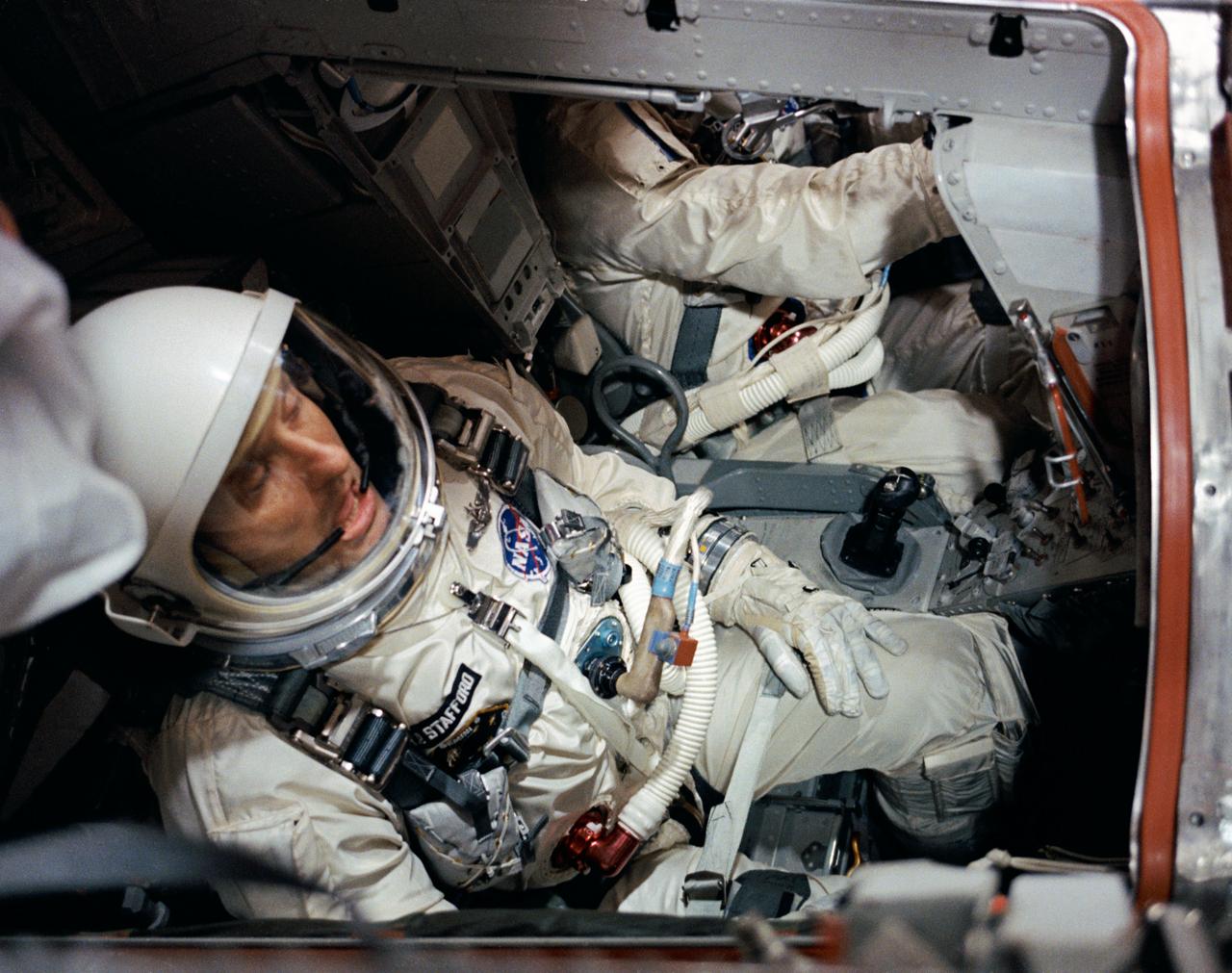 S65-59961 (15 Dec. 1965) --- Astronaut Thomas P. Stafford, pilot, is pictured in the Gemini-6 spacecraft in the White Room atop Pad 19 prior to the closing of the hatches during the Gemini-6 prelaunch countdown. In the background (partially out of view) is astronaut Walter M. Schirra Jr., command pilot. Photo credit: NASA or National Aeronautics and Space Administration
