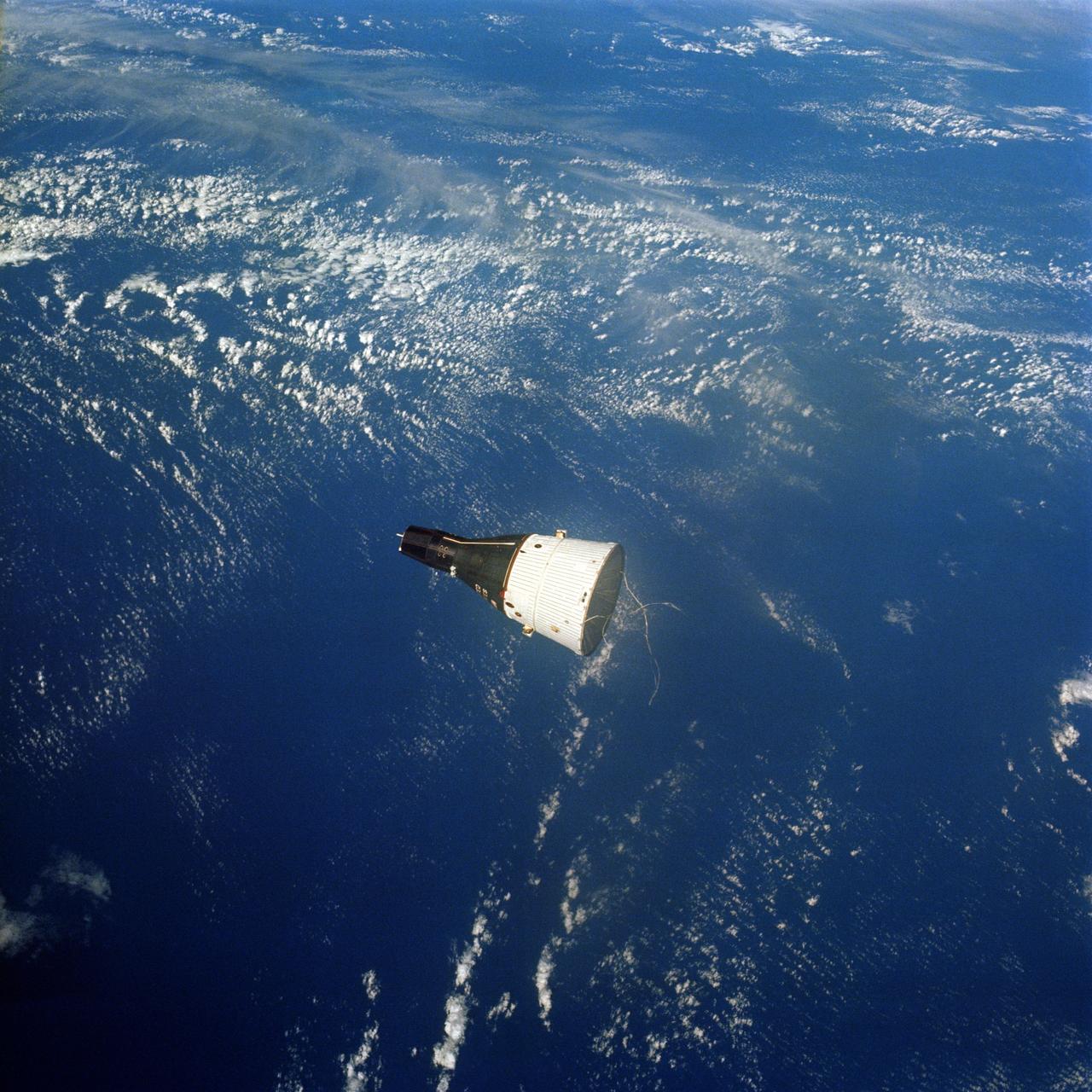 S65-63209 (15 Dec. 1965) --- The Gemini-7 spacecraft as seen from the Gemini-6 spacecraft during their rendezvous mission in space. The two spacecrafts are approximately 122 feet apart. This photo was taken with a modified 70mm Hasselblad camera. Photo credit: NASA or National Aeronautics and Space Administration