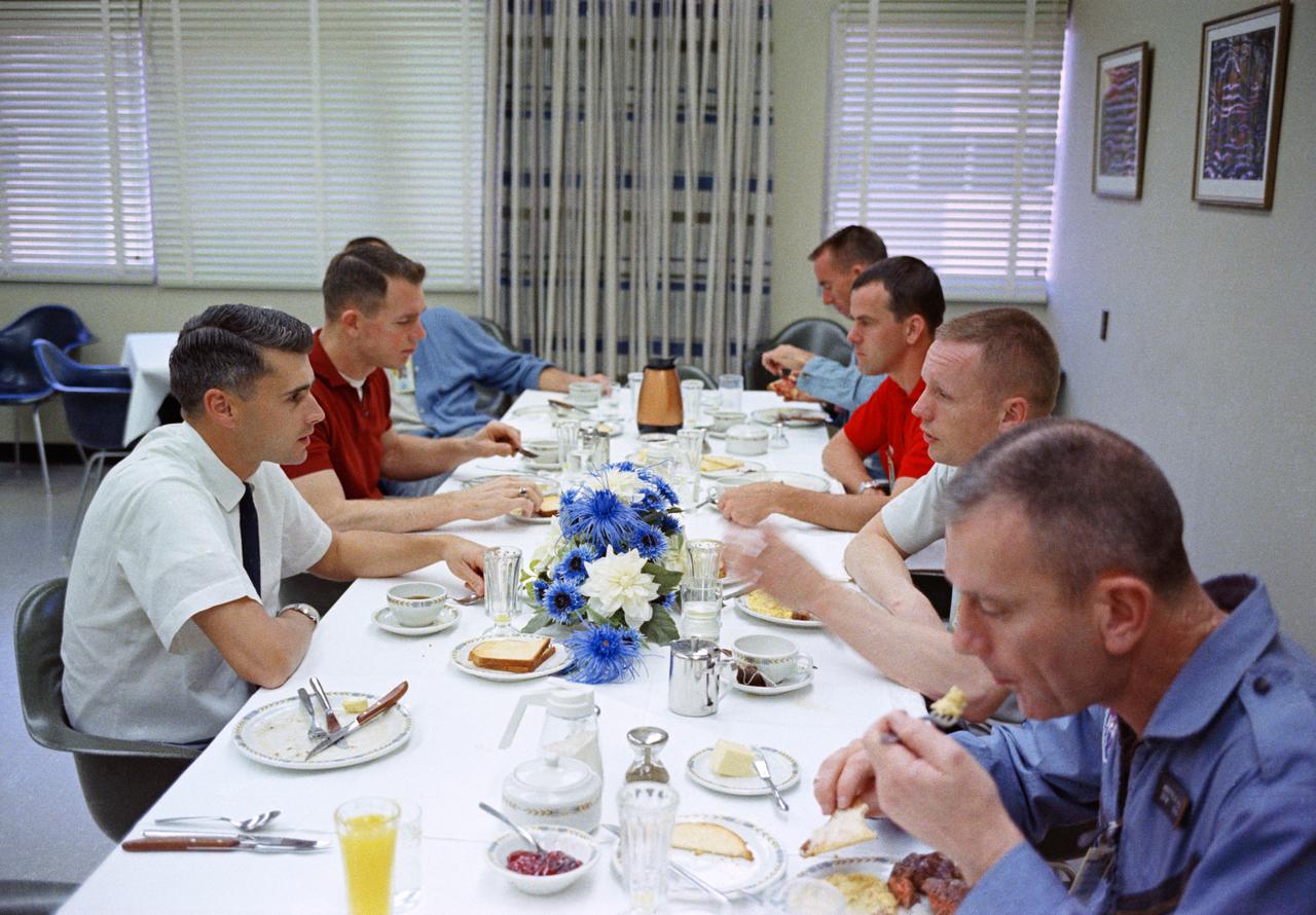 S66-24439 (16 March 1966) --- The Gemini-8 prime crew, along with several fellow astronauts, have a hearty breakfast of steak and eggs on the morning of the Gemini-8 launch. Seated clockwise around the table, starting at lower left, are Donald K. Slayton, Manned Spaceflight Center (MSC) Assistant Director for Flight Crew Operations; astronaut Neil A. Armstrong, Gemini-8 command pilot; scientist-astronaut F. Curtis Michel; astronaut R. Walter Cunningham; astronaut Alan B. Shepard Jr. (face obscured), Chief, MSC Astronaut Office; astronaut David R. Scott, Gemini-8 pilot; and astronaut Roger B. Chaffee. Photo credit: NASA