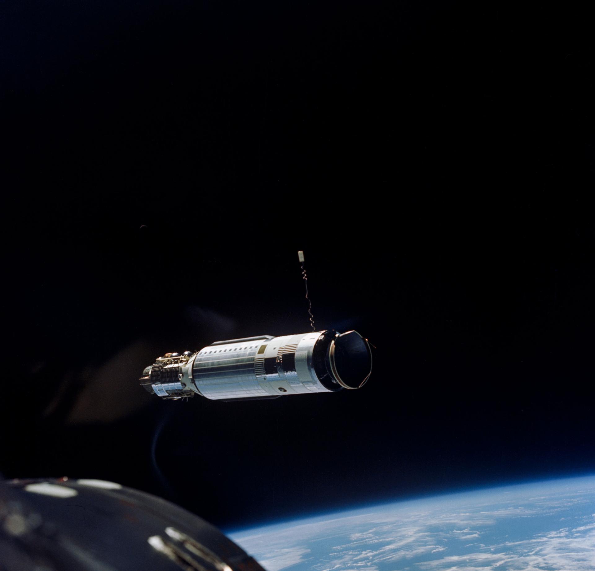 View of the Agena Target Docking vehicle in orbit above Earth as seen from the Gemini-8 spacecraft